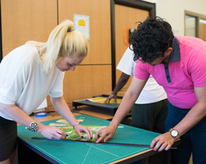 students work on a gridded mat